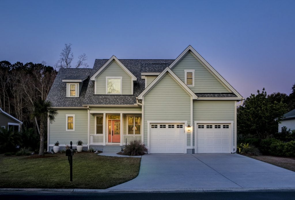 front elevation of beautiful home lit up at twilight